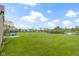 Expansive backyard with a serene pond view, green lawn, and brick home exterior at 8324 Thorn Bend Dr, Indianapolis, IN 46278