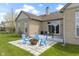 Backyard featuring patio with blue Adirondack chairs, landscaping and brick exterior at 8324 Thorn Bend Dr, Indianapolis, IN 46278