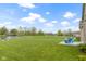Spacious backyard with pond view, Adirondack chairs, landscaping, and plenty of room at 8324 Thorn Bend Dr, Indianapolis, IN 46278