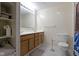 Bathroom featuring a double sink vanity, neutral tile, and storage shelves at 8324 Thorn Bend Dr, Indianapolis, IN 46278