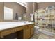Bathroom with a single sink vanity, a large mirror, and a shower with patterned curtain at 8324 Thorn Bend Dr, Indianapolis, IN 46278