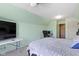 Bedroom with a bed, desk, and TV, and mint paint and ceiling fan at 8324 Thorn Bend Dr, Indianapolis, IN 46278