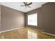 Neutral bedroom featuring hardwood floors, a ceiling fan, and a window at 8324 Thorn Bend Dr, Indianapolis, IN 46278