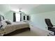 Bedroom with mint paint, a ceiling fan, window, a bed, and a desk with a TV at 8324 Thorn Bend Dr, Indianapolis, IN 46278