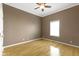 A cozy bedroom featuring hardwood floors, a ceiling fan, and a window for natural light at 8324 Thorn Bend Dr, Indianapolis, IN 46278
