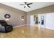 Bedroom featuring hardwood floors, modern light fixtures, and view into attached bathroom at 8324 Thorn Bend Dr, Indianapolis, IN 46278