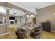 Spacious dining area with a modern glass table, upholstered chairs, chandelier, and views into other rooms at 8324 Thorn Bend Dr, Indianapolis, IN 46278