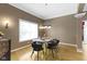 Stylish dining room featuring modern glass table, upholstered chairs, a chandelier, and lots of natural light at 8324 Thorn Bend Dr, Indianapolis, IN 46278