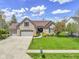 Charming single-story brick home with a three-car garage and beautifully landscaped front yard at 8324 Thorn Bend Dr, Indianapolis, IN 46278