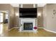 Elegant fireplace featuring a large mounted television, and decorative flower vases, all in a neutral color palette at 8324 Thorn Bend Dr, Indianapolis, IN 46278