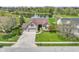 Inviting front exterior of a home with a manicured lawn, mature landscaping, and a view of a tranquil pond at 8324 Thorn Bend Dr, Indianapolis, IN 46278