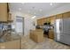 Well-lit kitchen with stainless steel appliances, a center island, and neutral tones at 8324 Thorn Bend Dr, Indianapolis, IN 46278