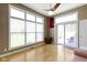 Living room features hardwood floors, ceiling fan, large windows, and backyard access at 8324 Thorn Bend Dr, Indianapolis, IN 46278