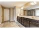 Bathroom with a dual sink vanity, large mirror, and tiled flooring, offering both style and functionality at 8330 Dumfries Dr, Brownsburg, IN 46112