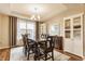 Elegant dining room featuring a dark wood table, chandelier, and natural light from the window at 8330 Dumfries Dr, Brownsburg, IN 46112