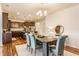 Bright dining area featuring an elegant table, chairs, and a view into the kitchen, all illuminated by a stylish chandelier at 8330 Dumfries Dr, Brownsburg, IN 46112