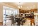Open-concept dining area connected to the kitchen and living room, featuring a dining table with chairs and bench seating at 8330 Dumfries Dr, Brownsburg, IN 46112