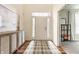 Inviting entryway featuring a patterned rug and a charming cabinet for storing shoes and other items at 8330 Dumfries Dr, Brownsburg, IN 46112