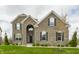 Stunning two-story brick home with manicured lawn and dark shutters against a cloudy sky at 8330 Dumfries Dr, Brownsburg, IN 46112