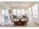 Cozy sunroom featuring comfortable seating, natural light from large windows, and access to a deck at 8330 Dumfries Dr, Brownsburg, IN 46112