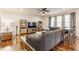 Spacious living room featuring hardwood floors, a large sectional, and bright windows at 8330 Dumfries Dr, Brownsburg, IN 46112