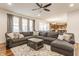 Inviting living room with a sectional sofa, decorative pillows, and view into the open kitchen at 8330 Dumfries Dr, Brownsburg, IN 46112
