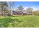Expansive backyard featuring a lush lawn and mature trees, offering privacy and space at 8639 Lancaster Rd, Indianapolis, IN 46260