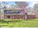 Backyard featuring a lawn, trees, brick exterior, and a patio area at 8639 Lancaster Rd, Indianapolis, IN 46260