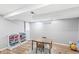 Finished basement with a table, toy storage, and laminate flooring at 8639 Lancaster Rd, Indianapolis, IN 46260