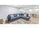 Finished basement with a blue couch, area rug, and a table with chairs at 8639 Lancaster Rd, Indianapolis, IN 46260