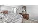 Cozy bedroom featuring a queen-sized bed, vintage dressers, and ensuite bathroom access at 8639 Lancaster Rd, Indianapolis, IN 46260
