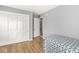 Clean bedroom with wood floors, closet, adjacent room, and plenty of natural light from the window at 8639 Lancaster Rd, Indianapolis, IN 46260