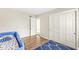 Cozy bedroom with hardwood floors, blue rug, closet, and a whimsical toddler bed for a fun and restful space at 8639 Lancaster Rd, Indianapolis, IN 46260