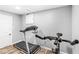 Home gym featuring a treadmill and exercise bike with ample space for workouts at 8639 Lancaster Rd, Indianapolis, IN 46260