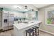 Eat-in kitchen with stainless steel refrigerator, microwave, and central island with breakfast bar at 8639 Lancaster Rd, Indianapolis, IN 46260