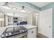 Open kitchen with modern stove top connecting to a living room with a fireplace and built-in shelving at 8639 Lancaster Rd, Indianapolis, IN 46260