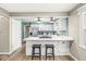 Kitchen area showing white cabinetry, a central island with seating, and stainless steel appliances at 8639 Lancaster Rd, Indianapolis, IN 46260