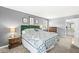 Spacious main bedroom with plush bed, carpeting, side tables, and connecting bathroom for a private retreat at 8639 Lancaster Rd, Indianapolis, IN 46260