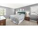Bright main bedroom with a plush bed, side tables, carpeting, and neutral walls creating a peaceful retreat at 8639 Lancaster Rd, Indianapolis, IN 46260