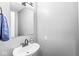Half bathroom with a vanity, mirror, and towel hook at 8639 Lancaster Rd, Indianapolis, IN 46260
