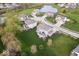 Lush aerial view of a suburban neighborhood with winding streets, mature trees, and diverse home designs at 957 Commander Ct, Westfield, IN 46074