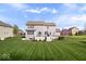 Expansive backyard with a well-maintained lawn, a deck, and picturesque views at 957 Commander Ct, Westfield, IN 46074