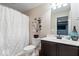 Cozy bathroom featuring a shower with curtain, single sink vanity and decorative accents at 957 Commander Ct, Westfield, IN 46074