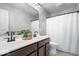 Stylish bathroom with double sinks, framed mirrors, dark wood cabinets, and a tiled floor at 957 Commander Ct, Westfield, IN 46074