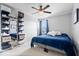 Stylish bedroom with a navy blue comforter, wall décor, and shelving unit for shoe storage at 957 Commander Ct, Westfield, IN 46074