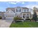 Charming two-story home with a manicured lawn, a three-car garage, and a welcoming front porch with white columns at 957 Commander Ct, Westfield, IN 46074