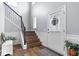 Bright foyer featuring hardwood floors, a staircase with decorative trim, and a white front door with sidelight at 957 Commander Ct, Westfield, IN 46074