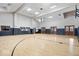 Large gymnasium featuring a basketball court with hardwood floors and natural light, perfect for sports and recreation at 957 Commander Ct, Westfield, IN 46074