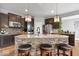 Stylish kitchen island has stone accents, granite countertop, and modern lighting at 957 Commander Ct, Westfield, IN 46074