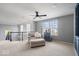 Bright living room with chair, ottoman, staircase, and a gray shelving unit with decorative items at 957 Commander Ct, Westfield, IN 46074